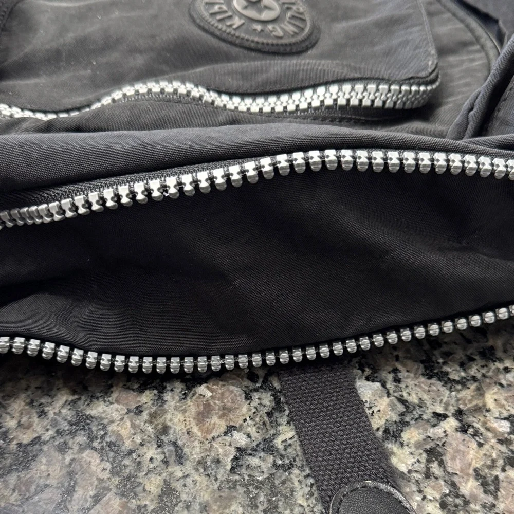 Kipling Hal Expandable Black Backpack with large Silver Accent zippers EUC